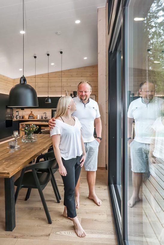 Ett svart timmerhus i lantlig miljö